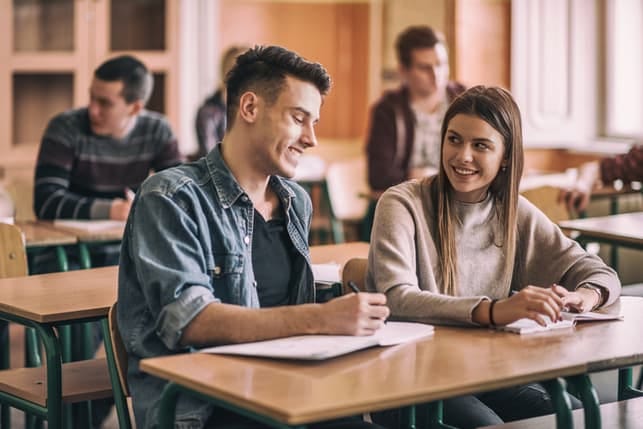 a young couple is talking while being on classes