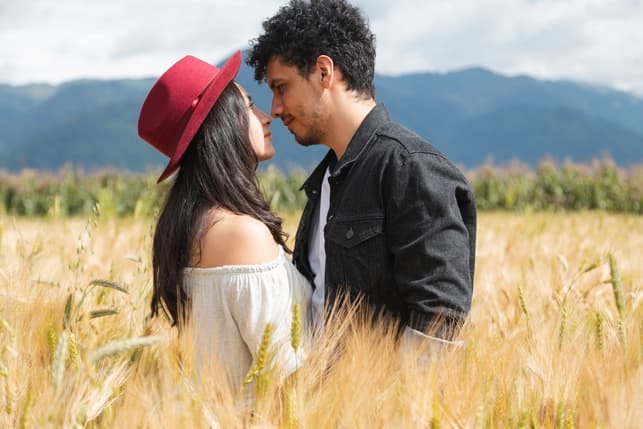 a romantic couple posing in the field