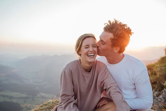 lovely couple laughing in the mountains