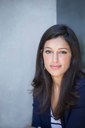 a portrait of a young dark-haired woman on a grey background