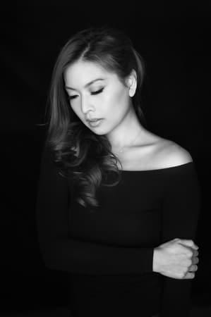 a black-and-white portrait of a sad asian woman