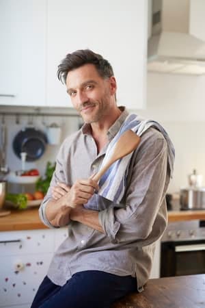 a handsome man cooking at home