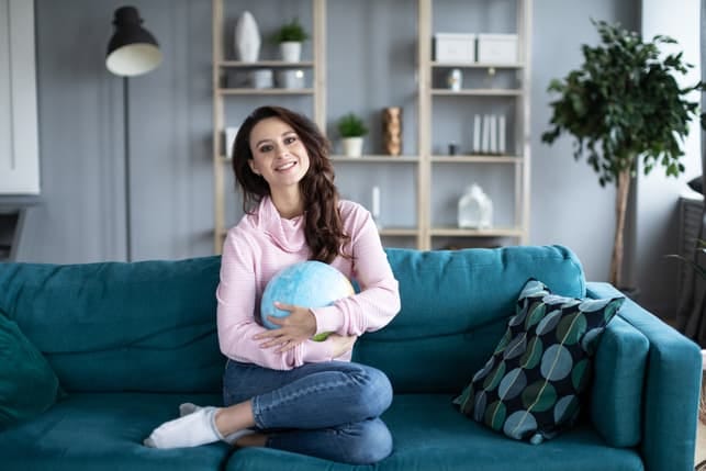 a beautiful woman is hugging a globus at home