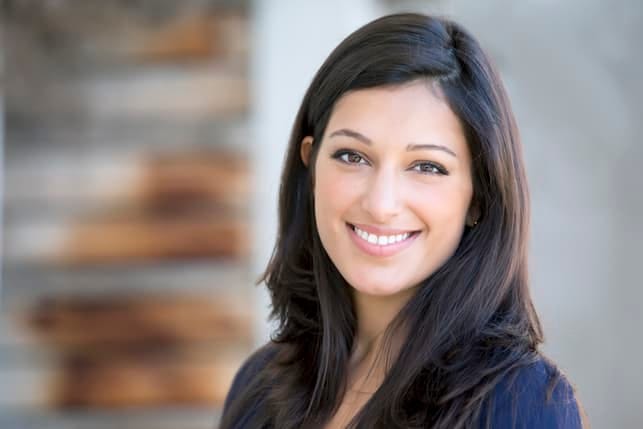 a portrait of a young dark-haired woman smiling